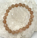 Natural peach moonstone 8mm gemstone bracelet from World Wide Gems Minerals Beads, featuring smooth, polished round beads.