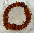 Dark natural Baltic amber flat nugget bracelet featuring 12mm-18mm beads from World Wide Gems Minerals Beads.