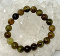 Natural green garnet 10mm gemstone round bracelet with polished beads, crafted by World Wide Gems Minerals Beads.