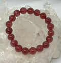 Natural strawberry quartz 10mm round gemstone bracelet with polished beads, featuring a vibrant pink color and smooth finish.