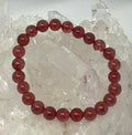Natural strawberry quartz 8mm round gemstone bracelet featuring pinkish red beads from World Wide Gems Minerals Beads.