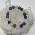 Collection of 10mm round gemstone bracelets featuring amethyst, green aventurine, and rose quartz from World Wide Gems Minerals Beads.