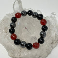 Carnelian Triple Protection 12mm round bracelet set with three mineral beads, featuring natural orange and red stones from World Wide Gems.