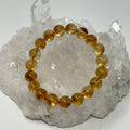 Citrine 10mm round beaded bracelet from World Wide Gems Minerals Beads featuring polished yellow-orange gemstones.