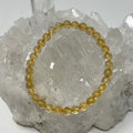 Citrine 6mm round gemstone bracelet from World Wide Gems Minerals Beads featuring polished yellow-orange beads.