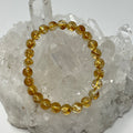 Citrine 8mm round gemstone bracelet by World Wide Gems Minerals Beads featuring polished citrine beads on a stretchy cord.