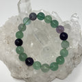 Rainbow Fluorite 10mm round bracelet set by World Wide Gems featuring three colorful, polished gemstone bracelets.