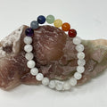 Rainbow Moonstone bracelet with 7-mineral chakra 8mm round beads, featuring a colorful, polished gemstone design.