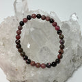 Set of three Rhodonite 6mm round gemstone bracelets by World Wide Gems Minerals Beads displayed together.