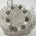 White and grey moonstone 12mm round bracelet by World Wide Gems Minerals Beads featuring smooth, polished gemstone beads.