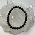 6mm black sheen obsidian round bracelet by World Wide Gems Minerals Beads, featuring polished black gemstone beads.