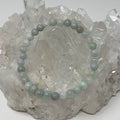 6mm green Burma jade round bracelet from World Wide Gems Minerals Beads, featuring polished jade beads on a stretchy cord.