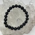 Arfvedsonite round bracelet featuring 7mm-8mm beads from World Wide Gems Minerals Beads, showcasing dark, polished gemstone beads.