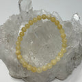 Aragonite 6mm round bracelet from World Wide Gems Minerals Beads, featuring smooth natural beige stone beads on an elastic band.