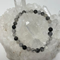 Black rutilated and tourmalinated quartz 6mm-7mm round bracelet set featuring two bracelets with polished gemstone beads.