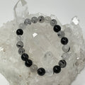 Two black rutilated and tourmalinated quartz round bracelets, 9mm-10mm beads, from World Wide Gems Minerals Beads.