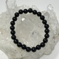 Black Tourmaline 8mm round bracelet set with three beaded bracelets from World Wide Gems Minerals Beads, showcasing polished gemstone beads.