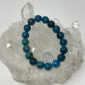 Blue Apatite 10mm round gemstone bracelet by World Wide Gems Minerals Beads, featuring polished blue apatite beads on an elastic band.