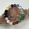 Chakra 10mm round bracelet featuring green aventurine, carnelian, rose quartz, sodalite, crystal quartz, black agate, and aragonite beads.