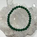 Three green agate round bracelets, 6mm beads, part of a 3-piece set by World Wide Gems Minerals Beads, displayed on a neutral background.