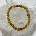 Honey Tiger 6mm Eye Round Bracelet by World Wide Gems Minerals Beads featuring polished tiger eye beads with a smooth round shape.