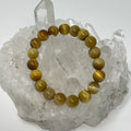 Honey Tiger Eye 10mm round bracelet set by World Wide Gems Minerals Beads, featuring two stylish tiger eye gemstone bracelets.