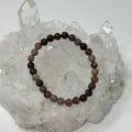 Red petrified wood 6mm round bracelet set by World Wide Gems Minerals Beads, featuring three stylish gemstone bracelets.