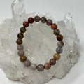 Red petrified wood 8mm round bracelet set by World Wide Gems Minerals Beads, featuring three matching natural stone bracelets.