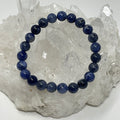 Sodalite 8mm round bracelet from World Wide Gems Minerals Beads featuring polished blue gemstone beads on a stretchy cord.