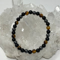 Yellow Tiger Eye triple protection 6mm round bracelet with three minerals, featuring polished beads on a stretch cord.