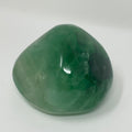 Bright green and purple fluorite mineral from World Wide Gems Minerals Beads, showcasing its vibrant crystal formations.