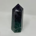 Natural fluorite mineral point with vibrant purple and green hues, showcasing its crystalline structure and mineral quality.