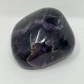 Vibrant green and purple fluorite mineral specimen from World Wide Gems Minerals Beads, showcasing its colorful crystal formations.