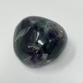 Vibrant green and purple fluorite mineral specimen from World Wide Gems Minerals Beads, showcasing its colorful crystalline structure.