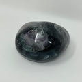 Bright green and purple fluorite mineral sample from World Wide Gems Minerals Beads, showcasing vibrant crystal formations.