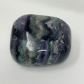 Bright green and purple fluorite mineral sample from World Wide Gems Minerals Beads, showcasing its vibrant, crystalline structure.