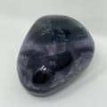Vibrant green and purple fluorite mineral specimen from World Wide Gems Minerals Beads, showcasing its colorful crystalline structure.