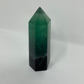 Bright green and purple fluorite mineral point from World Wide Gems Minerals Beads, showcasing smooth, polished mineral specimen.