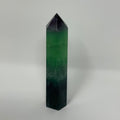Purple fluorite mineral point from World Wide Gems Minerals Beads, showcasing vibrant crystal formations and natural mineral textures.