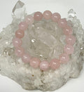 Rose Quartz 12mm round gemstone bracelet from WorldWideMinerals-beads, featuring polished pink quartz beads on an elastic band.