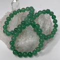 Set of three green jade 10mm round bracelets from WorldWideMinerals-beads, natural gemstone jewelry for stylish wrist accessories.